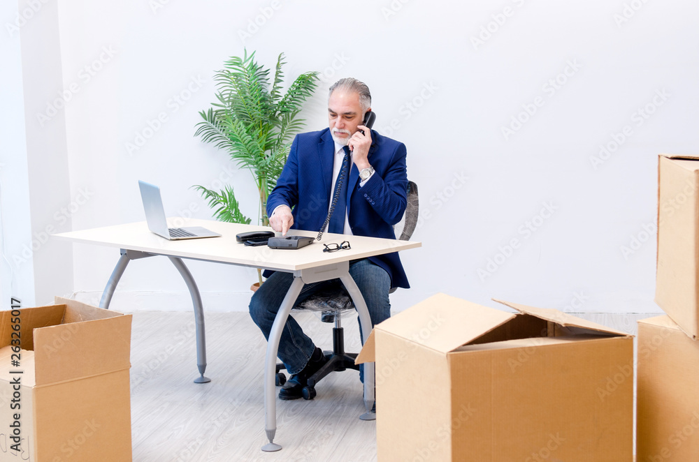 Aged businessman moving to new workplace Aged businessman moving to new workplace
