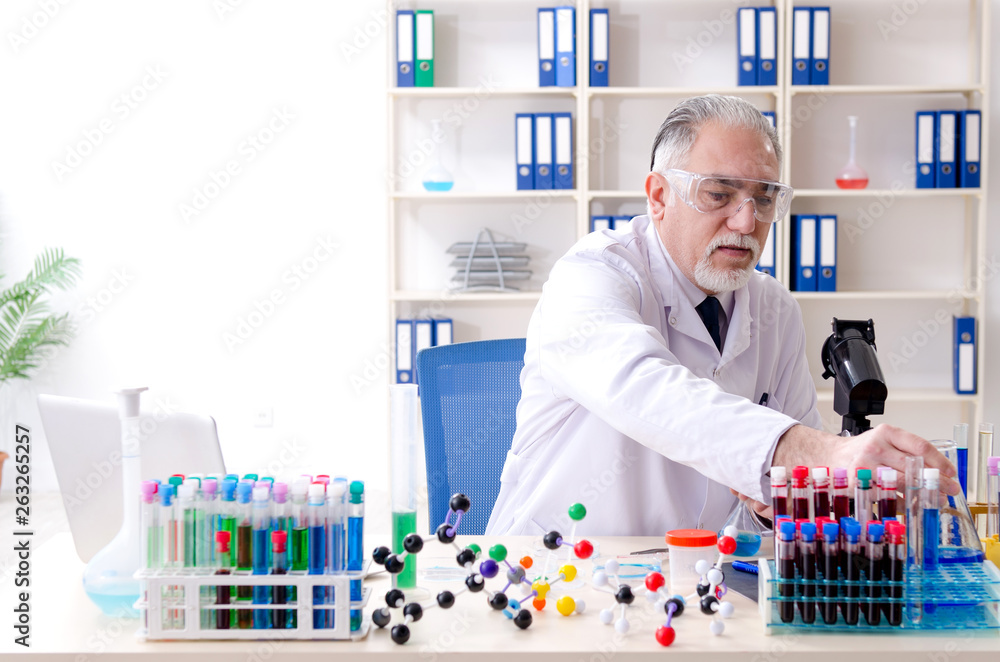 Old male chemist working in the lab Old male chemist working in the lab