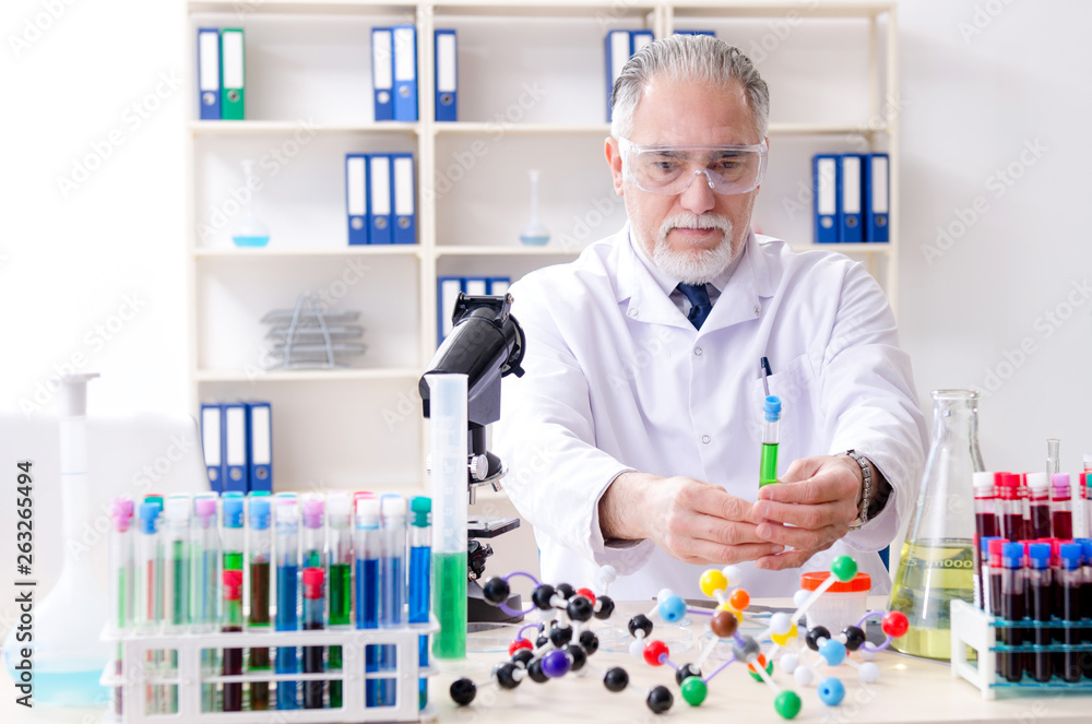 Old male chemist working in the lab Old male chemist working in the lab