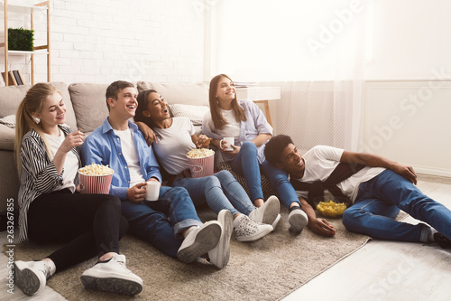 Fotografie Comedy film. Happy friends watching movie at home