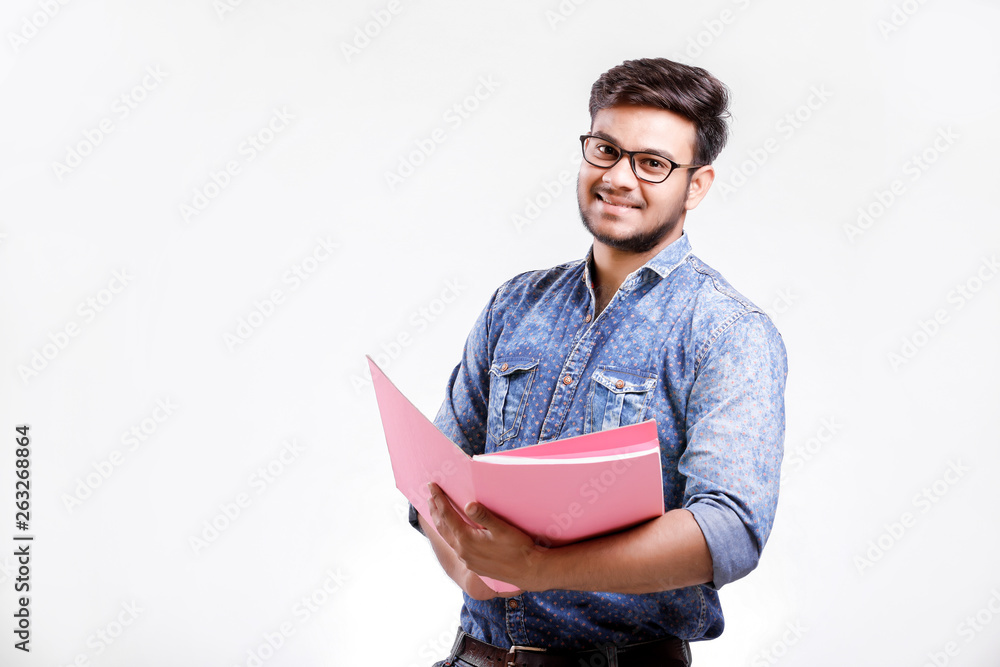 Young Indian man holding document file over white background Young Indian man holding document file over white background