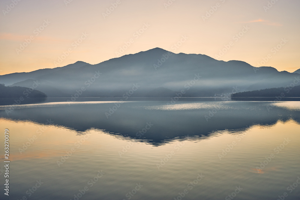 Beautiful sunrise scenics of Sun Moon Lake with the surrounding mountains are the highlight at this sprawling lake at Yuchi, Nantou in Taiwan.