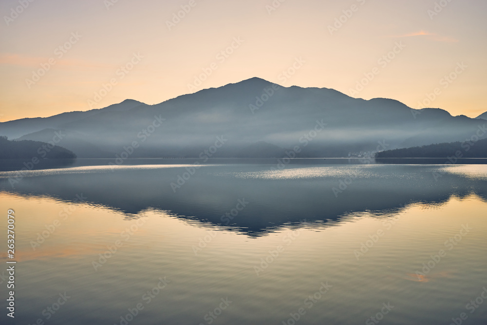 Beautiful sunrise scenics of Sun Moon Lake with the surrounding mountains are the highlight at this sprawling lake at Yuchi, Nantou in Taiwan. Beautiful sunrise scenics of Sun Moon Lake with the surrounding mountains are the highlight at this sprawling lake at Yuchi, Nantou in Taiwan.