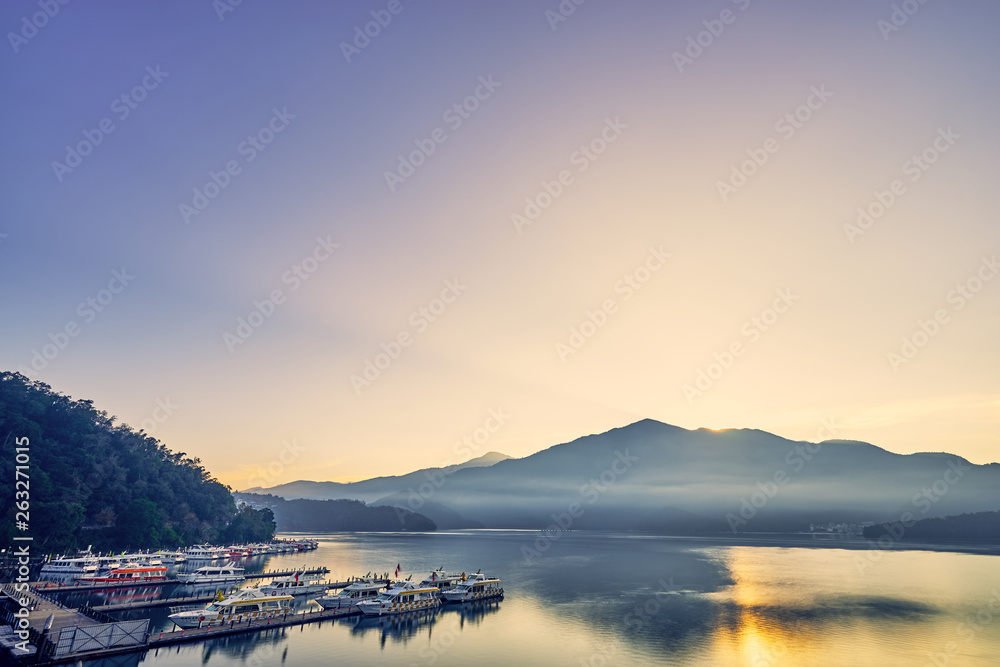 Nantou, Taiwan - December 8, 2018: Beautiful sunrise scenics of Sun Moon Lake with the surrounding mountains are the highlight at this sprawling lake at Yuchi, Nantou in Taiwan.