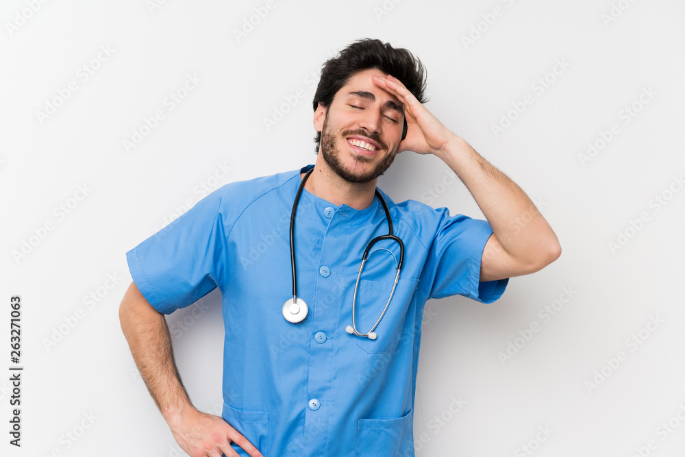 Surgeon doctor man over isolated white wall laughing Surgeon doctor man over isolated white wall laughing