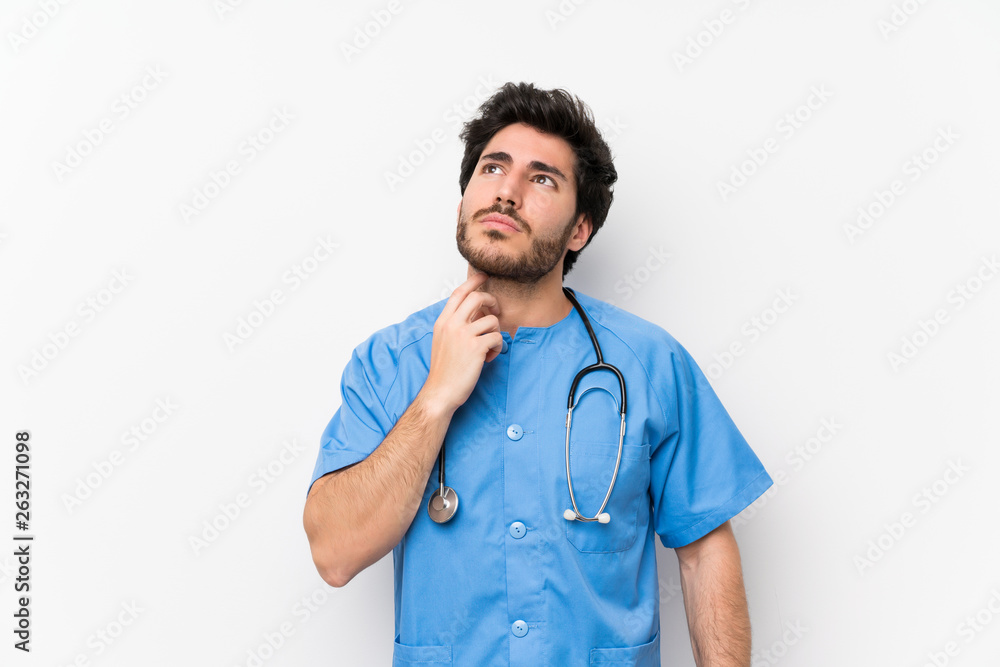 Surgeon doctor man over isolated white wall standing and thinking an idea Surgeon doctor man over isolated white wall standing and thinking an idea