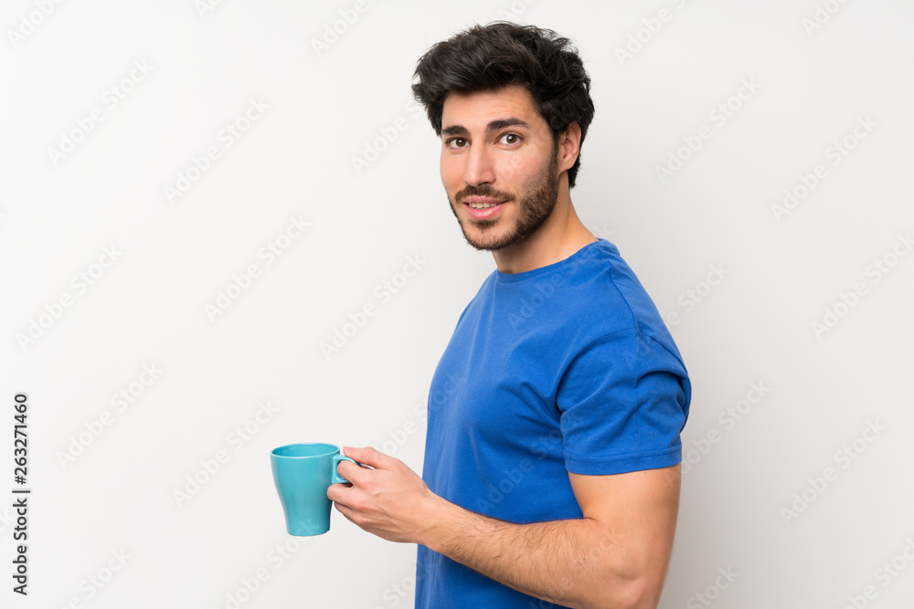 Handsome man holding hot cup of coffee Handsome man holding hot cup of coffee