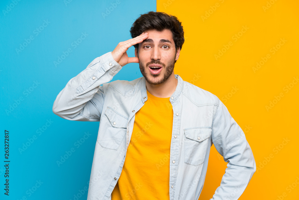 Handsome over isolated colorful background has just realized something and has intending the solution Handsome over isolated colorful background has just realized something and has intending the solution