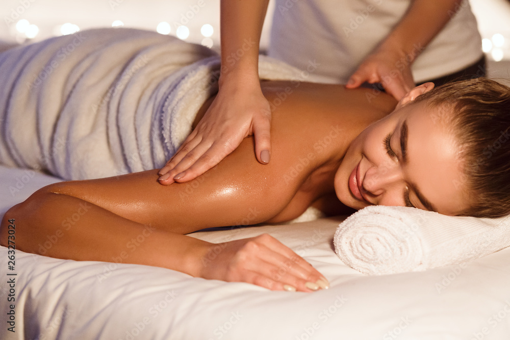 Woman enjoying shoulder massage in the health spa Woman enjoying shoulder massage in the health spa
