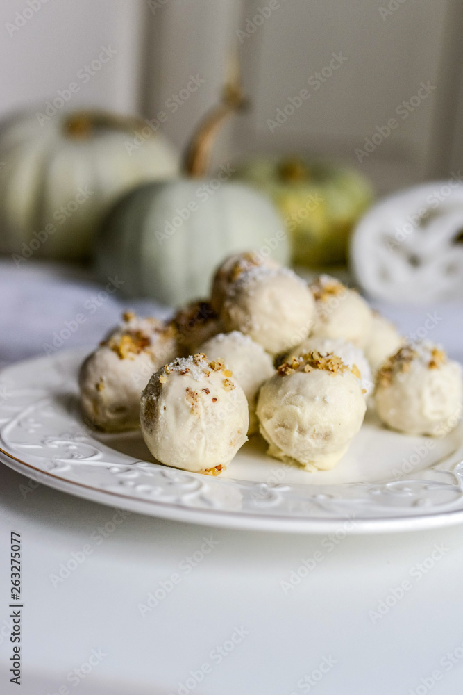 tasty homemade pumpkin candy balls in white chocolate topping of nut crumbs tasty homemade pumpkin candy balls in white chocolate topping of nut crumbs