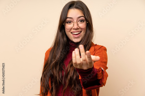 Photos Teenager girl with coat inviting to come
