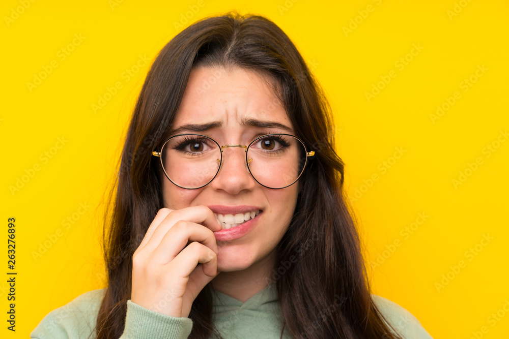 Teenager girl with sweatshirt nervous and scared Teenager girl with sweatshirt nervous and scared