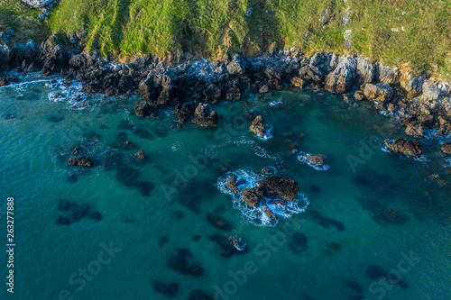 Sea waves breaking in the reefs and coast of Sonabia  Spain  Cantabrian sea - drone aerial view
