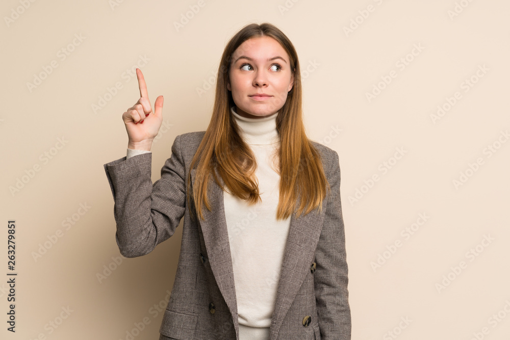Young business woman intending to realizes the solution while lifting a finger up Young business woman intending to realizes the solution while lifting a finger up