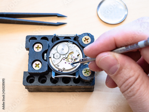 watchmaker fixes mechanism of mechanical watch