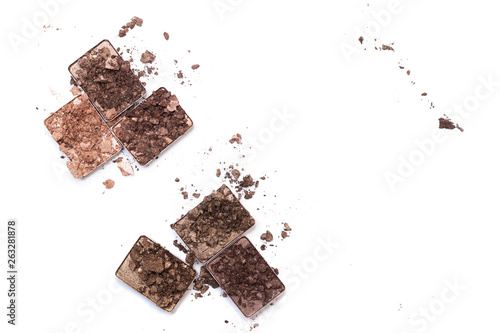 Broken make up and cosmetic products. Smashed eye shadow palette in neutral colors isolated on white background.