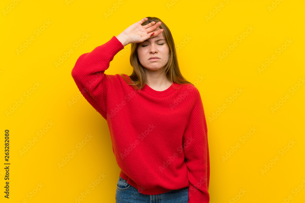 Young woman over yellow wall with tired and sick expression Young woman over yellow wall with tired and sick expression