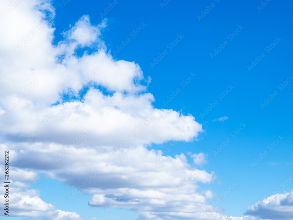 front of white clouds in blue sky front of white clouds in blue sky