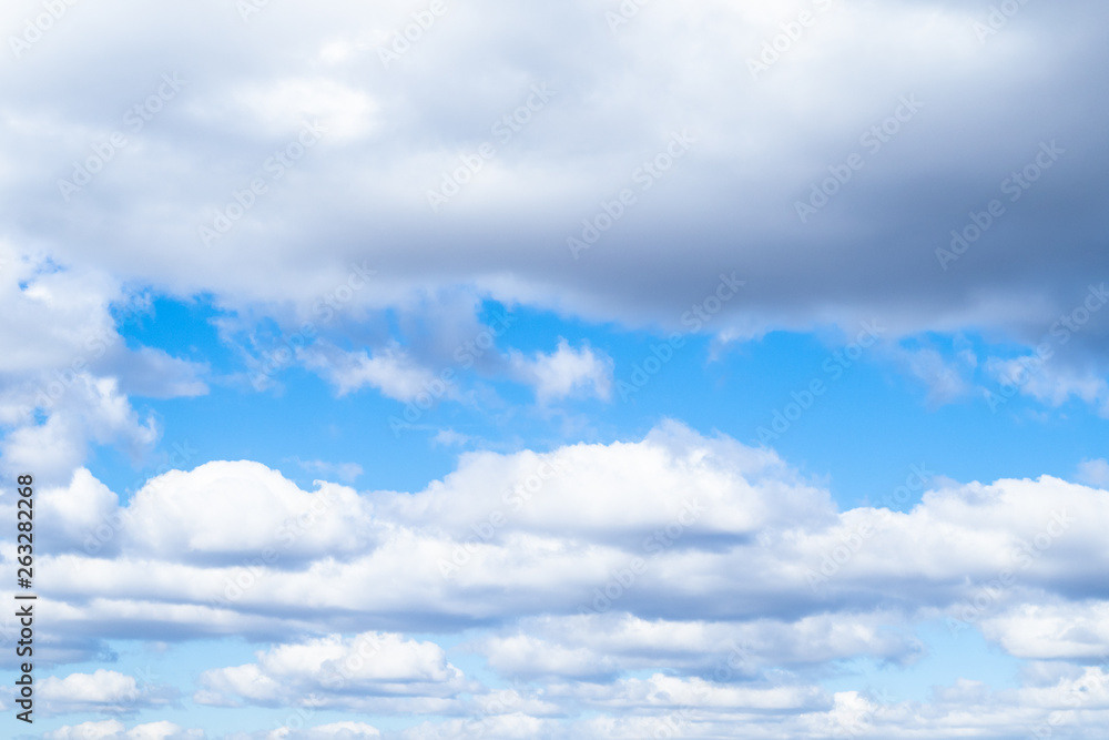 low white and gray cumulus clouds in blue sky low white and gray cumulus clouds in blue sky
