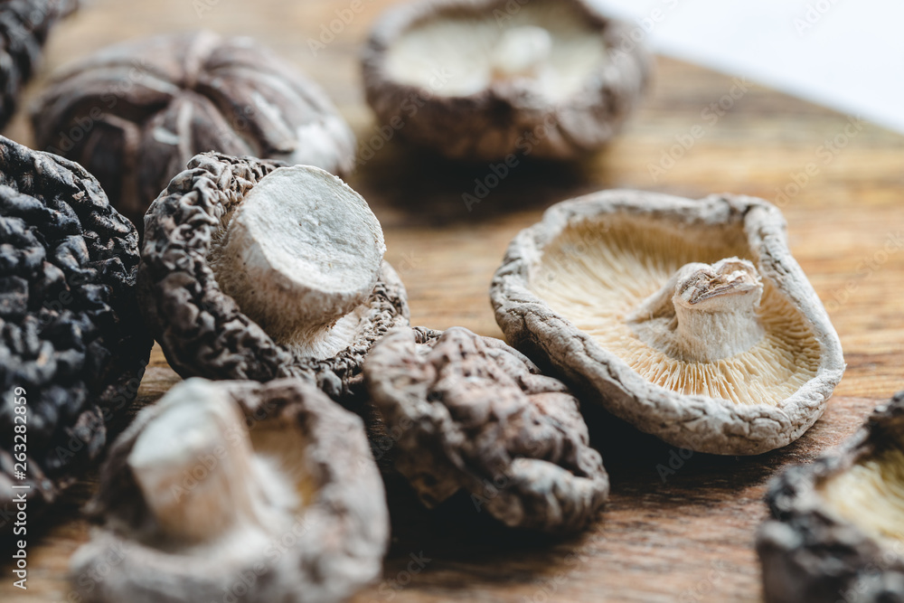 Macro photography of Chinese dried mushrooms Shiitake on a wooden kitchen board. Macro photography of Chinese dried mushrooms Shiitake on a wooden kitchen board.