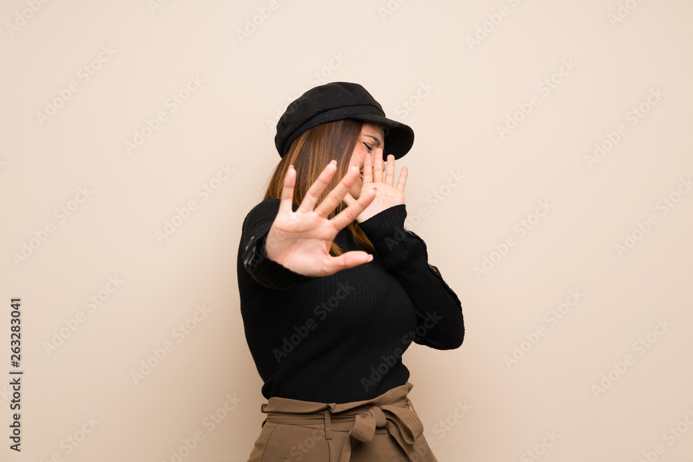 Fashion woman with hat nervous stretching hands to the front Fashion woman with hat nervous stretching hands to the front