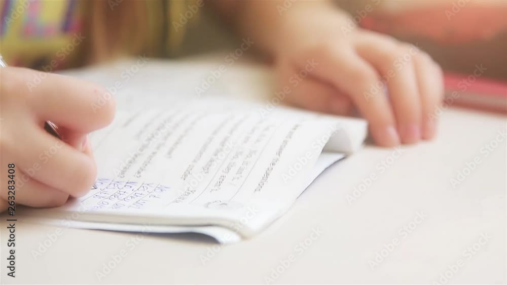 Girl sitting at the table doing homework in English HD 1920 Girl sitting at the table doing homework in English HD 1920