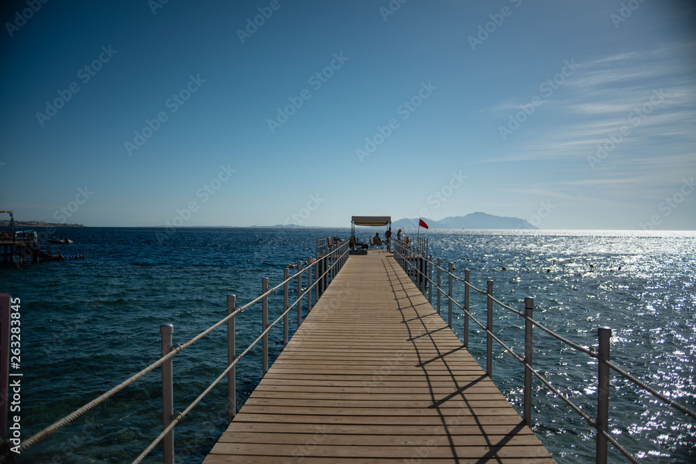 a long wooden pier in the sea
