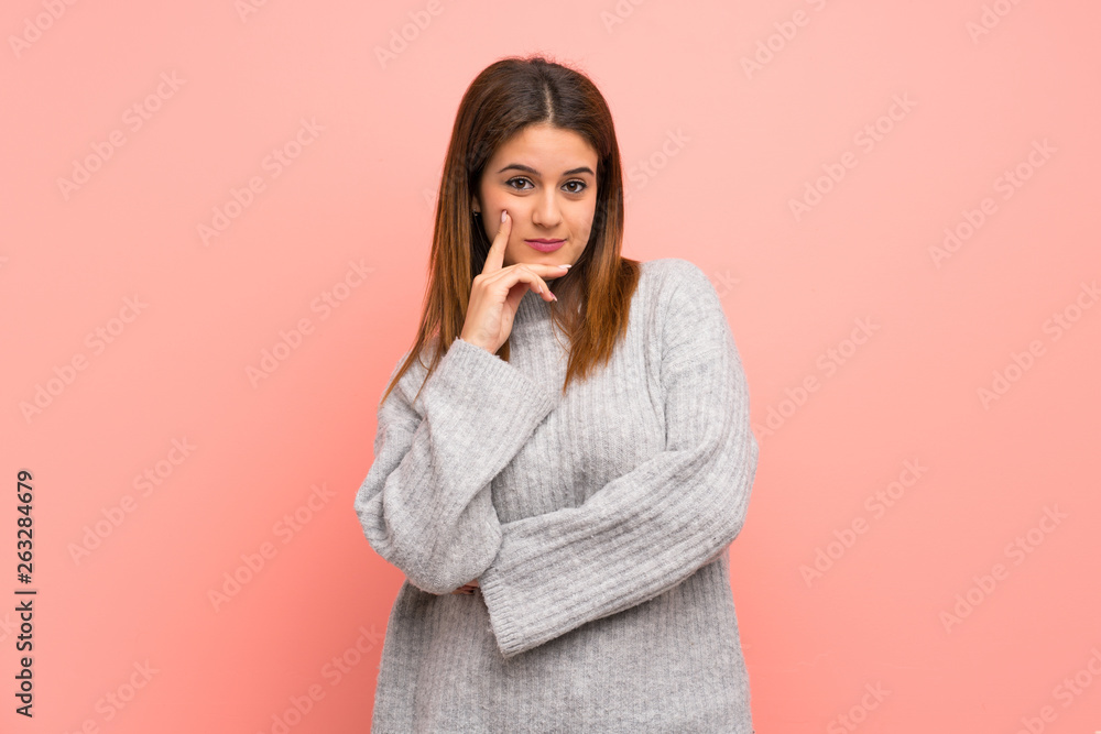 Young woman over pink wall thinking Young woman over pink wall thinking