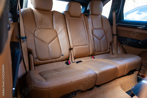 The interior of the car with a view of the rear seats and doors with light brown leather trim © Aleksandr Kondratov