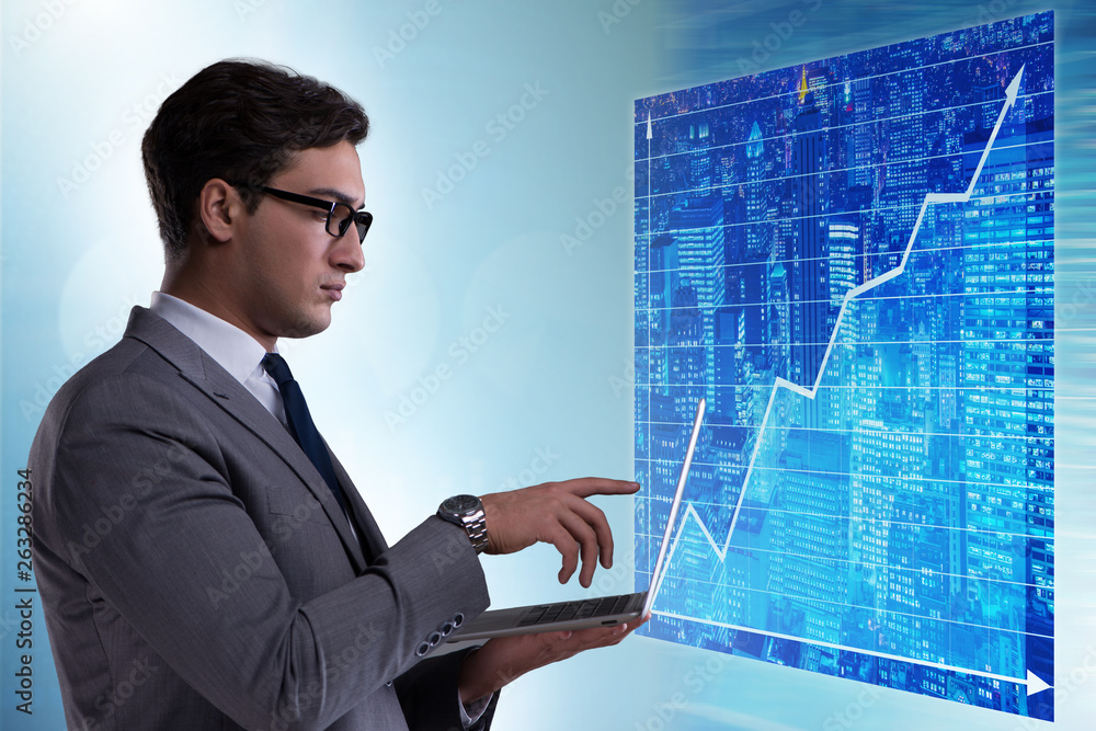 Businessman in futuristic stock trading concept Businessman in futuristic stock trading concept