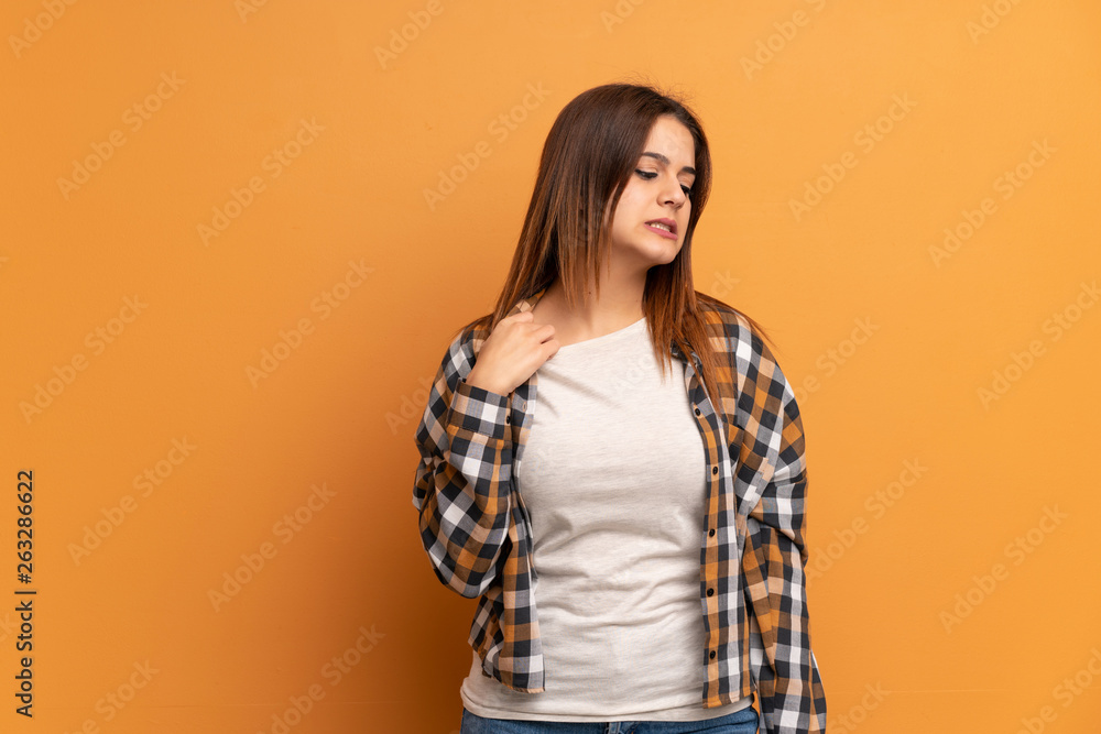 Young woman over brown wall with tired and sick expression Young woman over brown wall with tired and sick expression