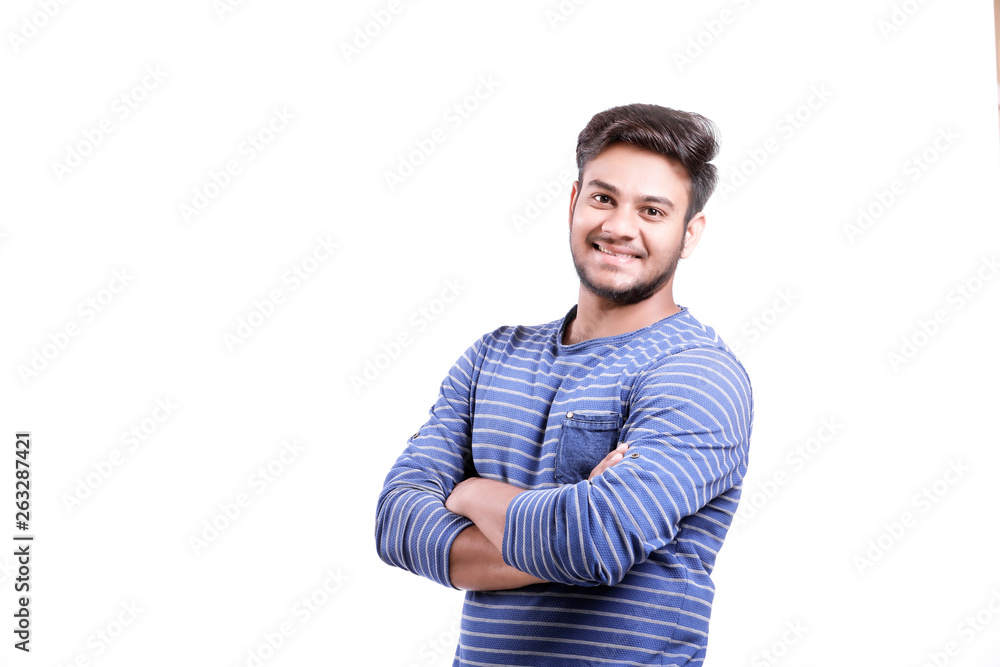 Handsome young Indian man standing with hands folded isolated over white background Handsome young Indian man standing with hands folded isolated over white background