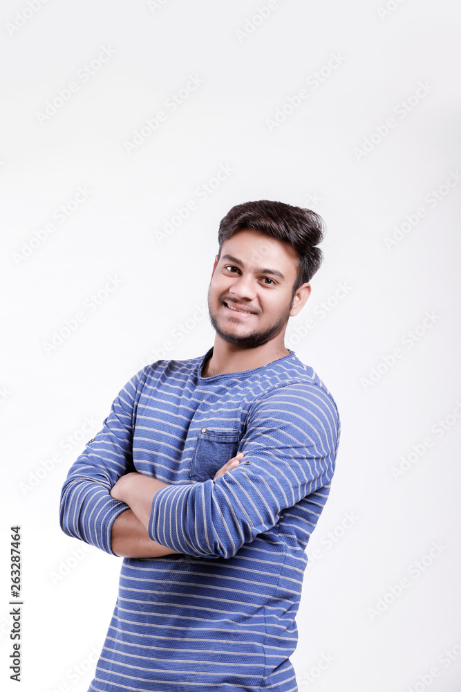 Handsome young Indian man standing with hands folded isolated over white background Handsome young Indian man standing with hands folded isolated over white background