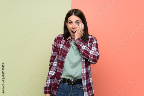 Young woman over isolated colorful wall with surprise and shocked facial expression © luismolinero