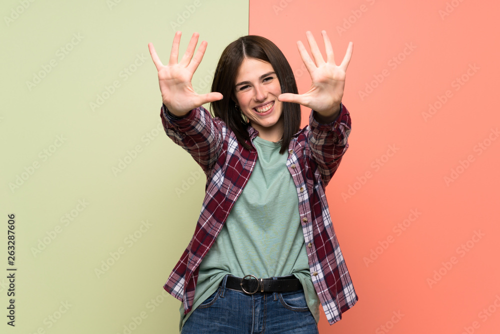Young woman over isolated colorful wall counting ten with fingers Young woman over isolated colorful wall counting ten with fingers