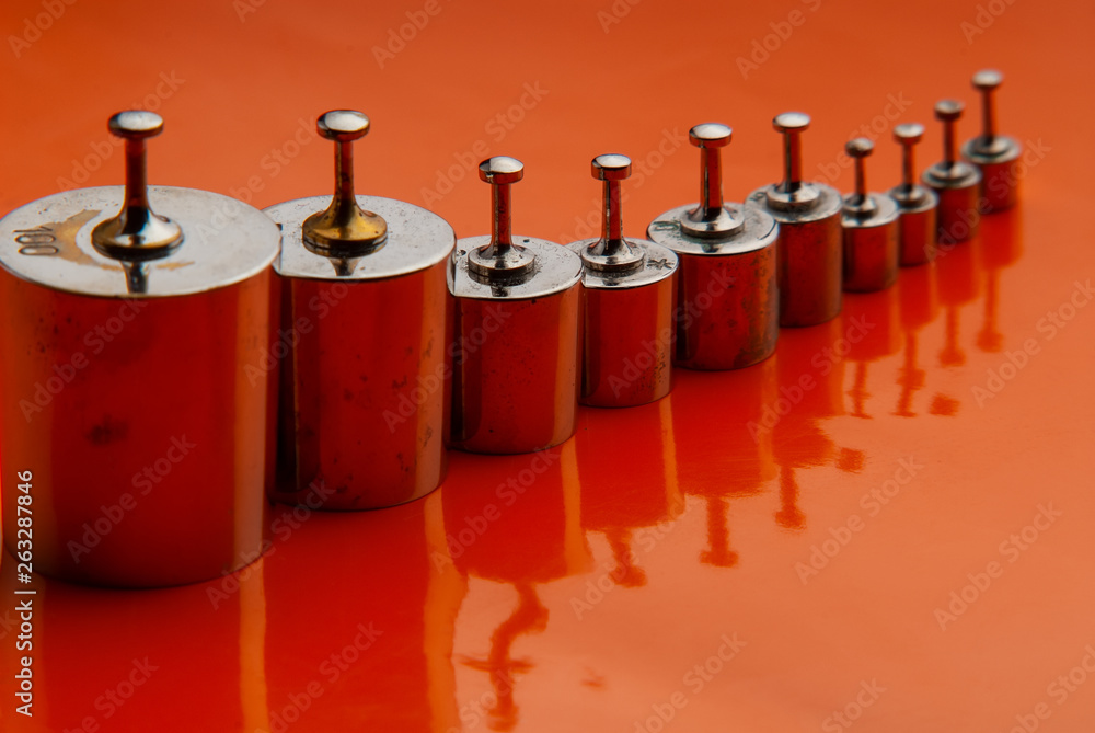 set of old kettlebells on an orange background. set of old kettlebells on an orange background.