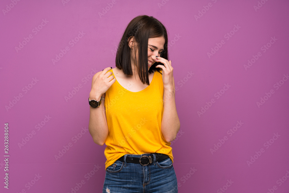 Young woman over isolated purple wall smiling a lot Young woman over isolated purple wall smiling a lot