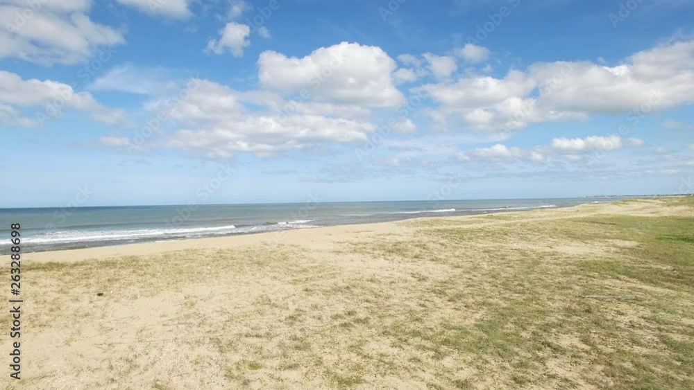 Low altitude forward aerial drone video hugging sand dune terrain of empty beach ascending to reveal the Mediterranean Sea Low altitude forward aerial drone video hugging sand dune terrain of empty beach ascending to reveal the Mediterranean Sea