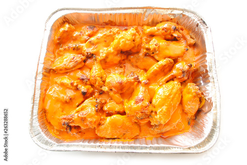 Spicy Hot Buffalo Wing Pieces in a Takeout Container 