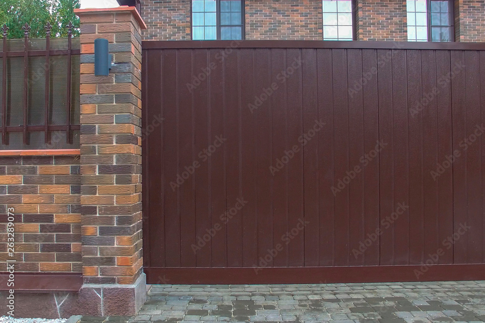 Iron sliding gates with brick wall for privacy and protection