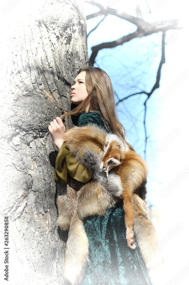 Woman in medieval dress and fox fur