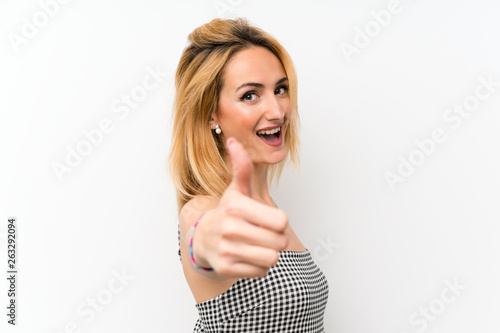 Wallpaper Mural Young blonde woman over isolated white with thumbs up because something good has happened Torontodigital.ca