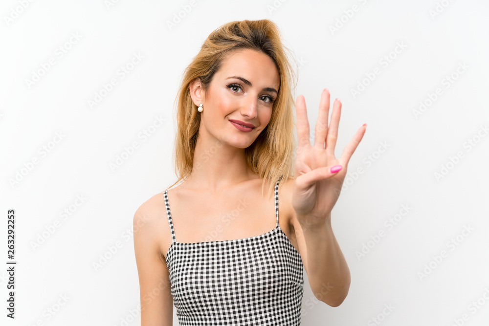 Young blonde woman over isolated white happy and counting four with fingers Young blonde woman over isolated white happy and counting four with fingers