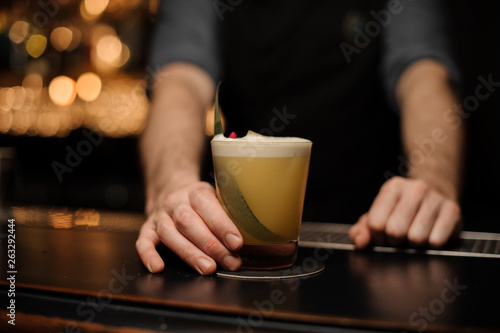 Close-up of alcohol cocktail held by bartender