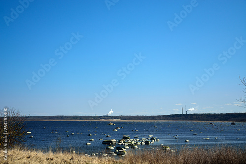 Landscape of the Baltic Sea. Smoke factory overseas.
