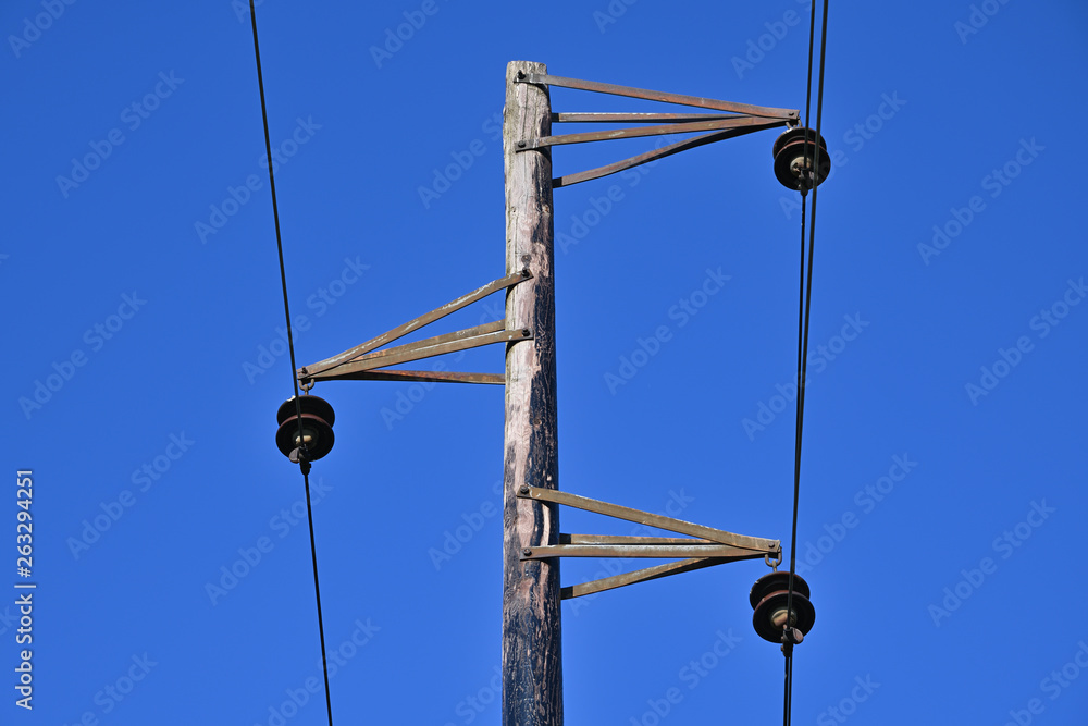 Vintage electric pole and wires. An old overhead power line and single wood  utility pole structure. Electrical power transmission and distribution  cables. Stock Photo | Adobe Stock