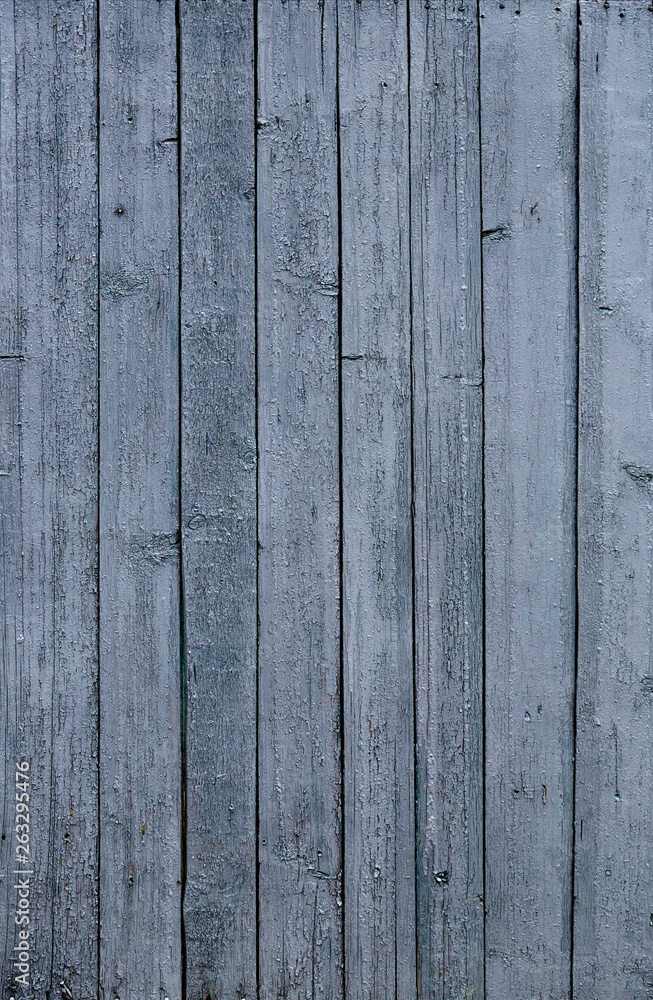 Obraz premium A fence of dark blue and grey turquoise boards. Blank background with a texture of wooden slats