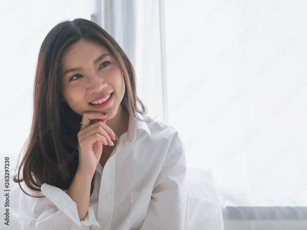 Closeup portrait of attractive young Asia woman smiling on morning weekend.