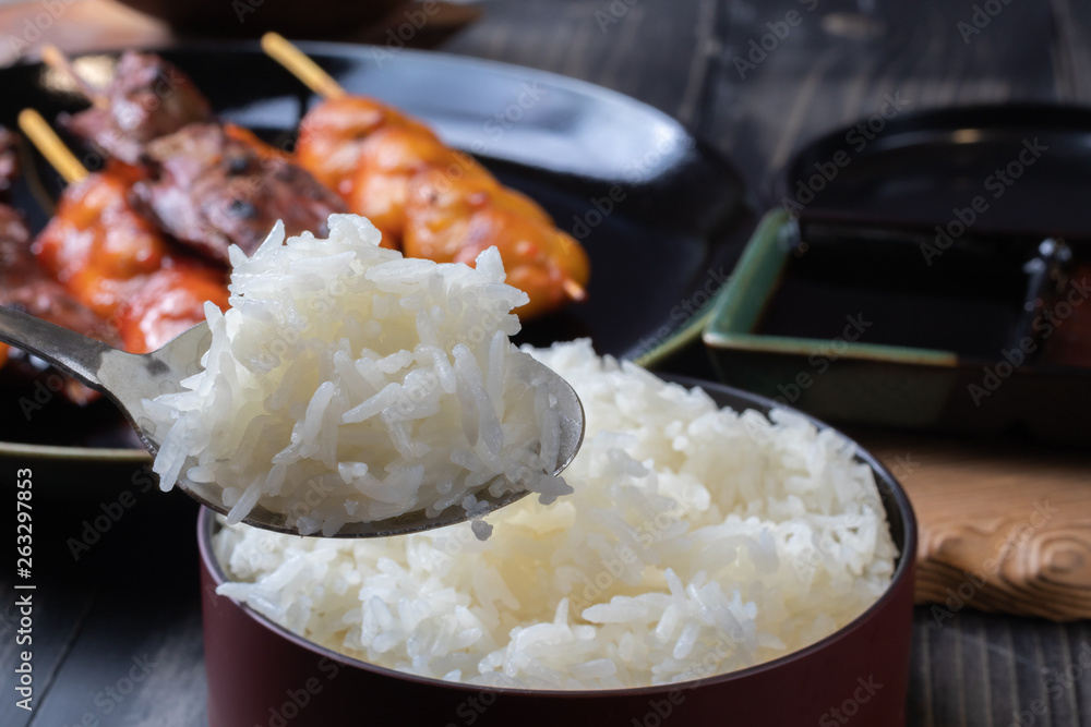 close up of steamed rice with grilled chicken