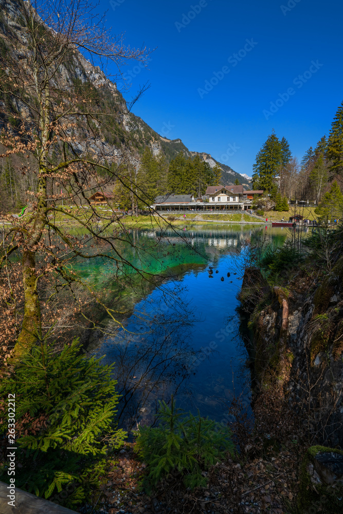 A house in front of Blue lake, Blausee, in Bernese Oberland, Switzerland